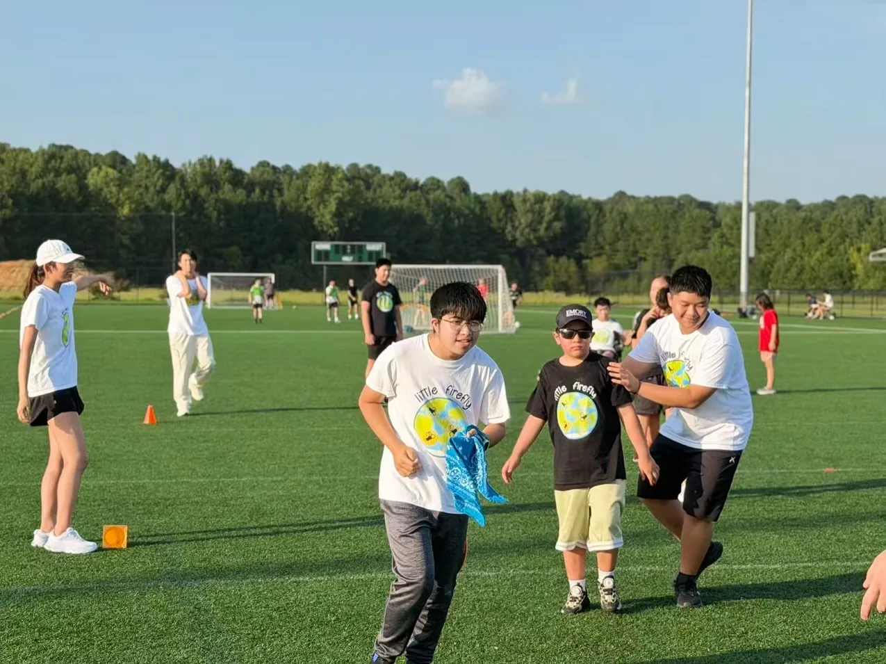 Participants and youth volunteers moving through an outdoor relay