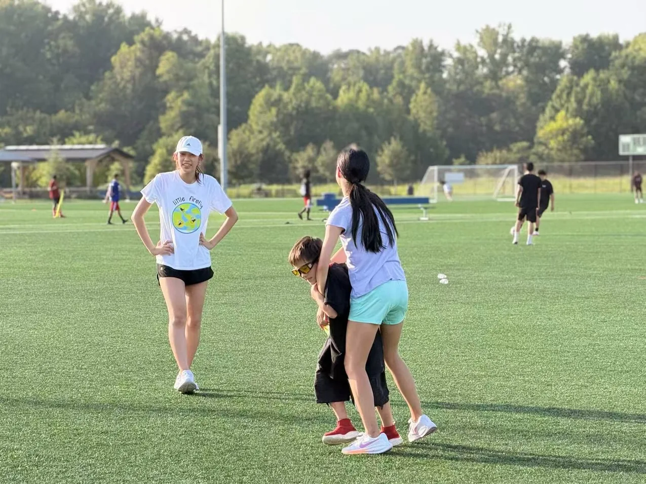 A youth volunteer supporting a participant during a field activity