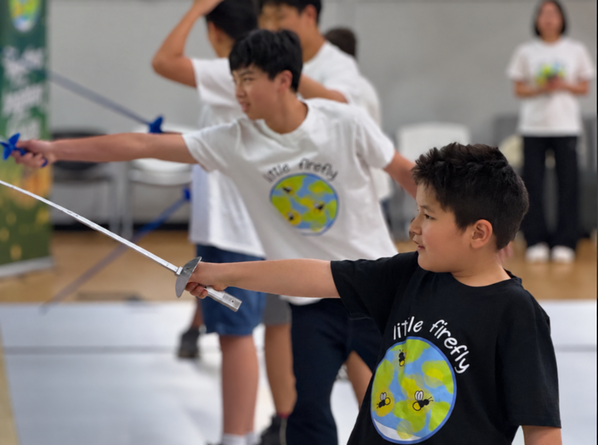 Participant practicing fencing at Little Firefly Taste of Fencing event